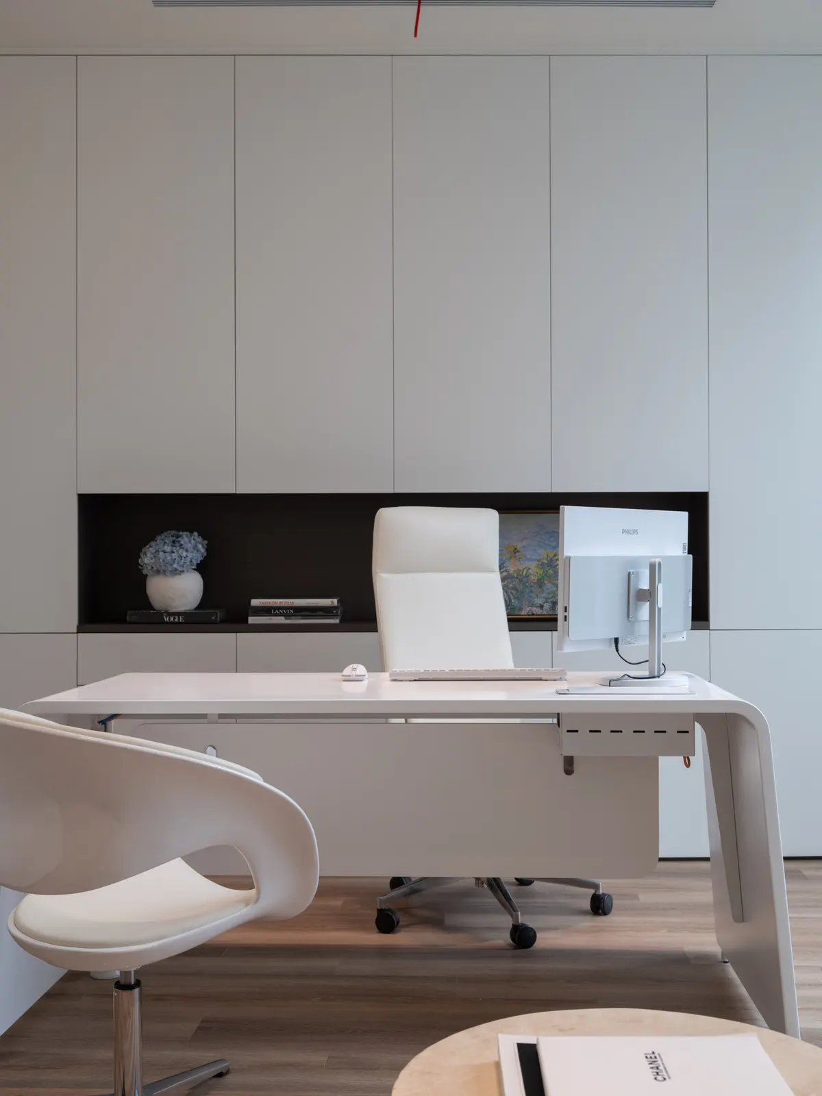 Consultation office with a white desk and imaging screen
